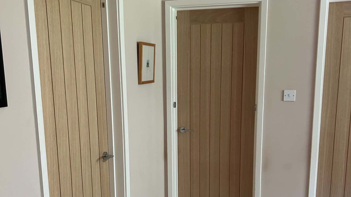 Hallway with three newly fitted oak internal doors and white architrave